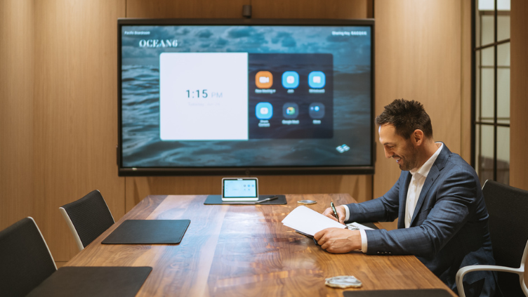 Financial advisor sitting in a boardroom preparing for a meeting, looking over a report