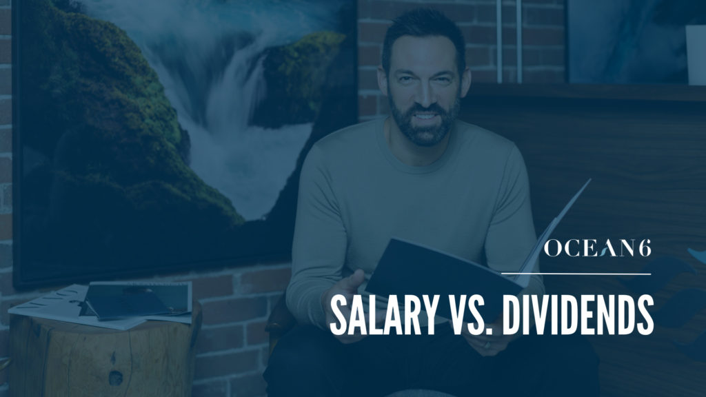 Financial advisor sitting down and smiling while holding a folder. A blog about How To Pay Yourself If You’re Incorporated = salary vs. dividends