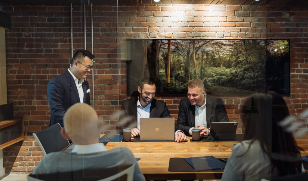 Financial advisors looking at laptop to discuss financial plan with clients