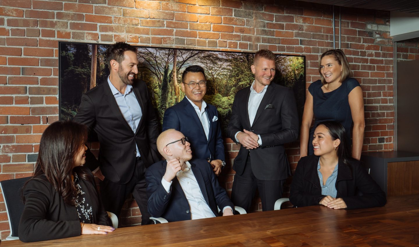 Financial firm team photos with colleagues smiling at each other