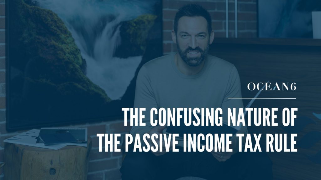 Blog thumbnail - the passive income tax rule explained. financial advisor sitting on a chair and holding a folder, smiling.