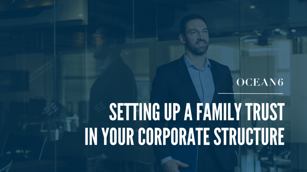 Financial advisor standing and smiling while holding a folder in a tux. A thumbnail for a blog on what is a family trust and how it benefits business owners
