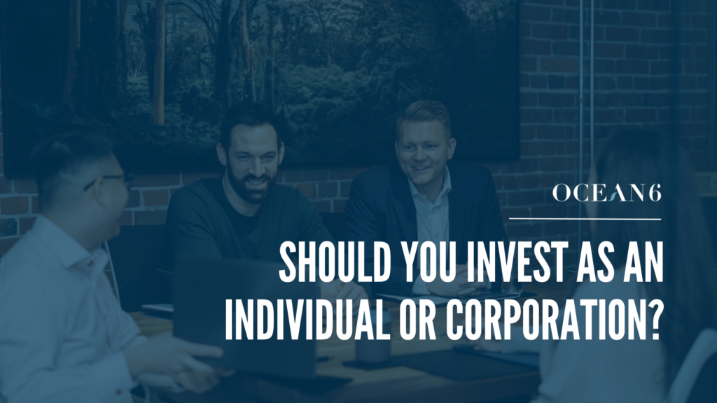 Three financial advisors sitting in a meeting and looking at data on a laptop while smiling. Thumbnail for a blog on investing corporately vs. personally