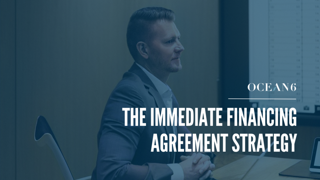 financial advisor sitting in a boardroom as a desk smiling - blog thumbnail on immediate financing agreement