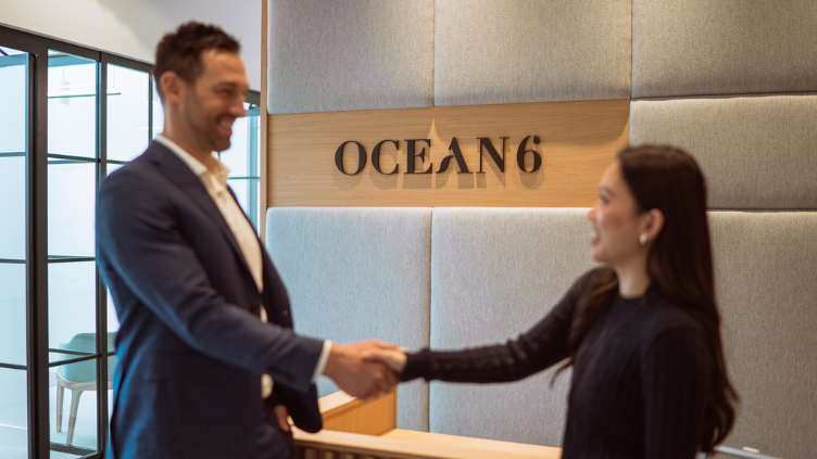 Financial planner and partner shaking hands at the reception area